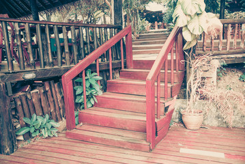 Old wooden stairs in the garden, selective focus on the steps, vintage tone.