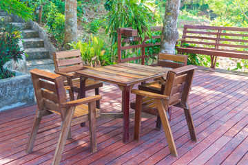 Wooden table and chair in resort and garden, dining set at wooden terrace in restaurant.