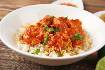 Plate with tasty chicken tikka masala and rice, closeup