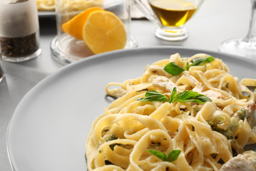 Delicious pasta alfredo with chicken on plate, closeup