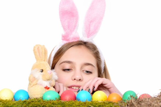 happy easter girl in bunny ears with colorful eggs, rabbit