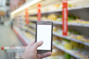 hand holding mobile smart phone on Supermarket blur background, business concept