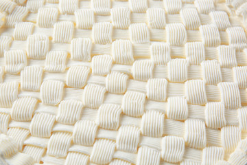 Cream decor on cheesecake, closeup