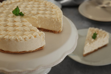 Fototapeta na wymiar Delicious plain cheesecake on white stand