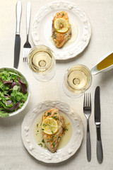 Plates with delicious chicken breasts on served table