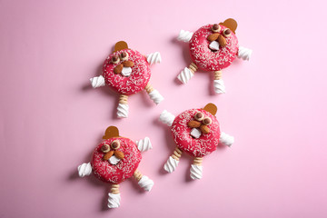 Funny decorated donuts on table