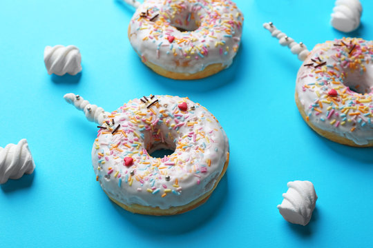 Funny decorated donuts on table