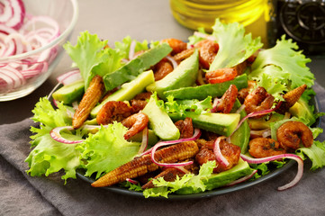 Salad with Teriyaki shrimps, avocado, lettuce and fried young corn. Close-up, selective focus.