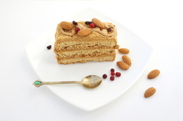 Cake with berries and almonds on a white plate. A tasty treat for tea