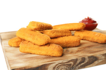 Wooden board with cheese sticks and ketchup sauce on white background