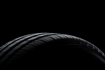 Car tire on black background