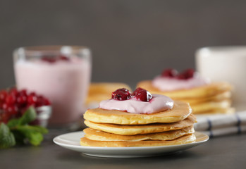 Delicious pancakes with yogurt and berries on  table