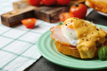 Plate with tasty egg Benedict on table