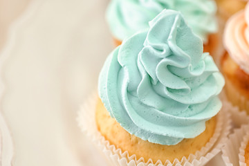 Tasty cupcake on plate, closeup