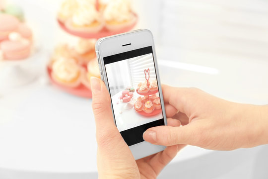 Female hands photographing food with smart phone