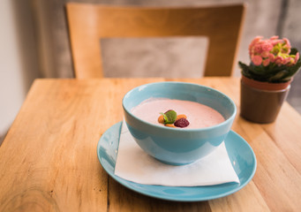 Delicious nutritious and healthy oatmeal with dried fruit on antique wood table