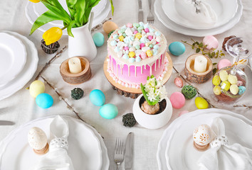 Table setting with beautiful cake and Easter decor