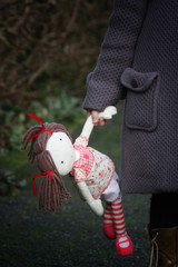 Sad child holding a doll, child protection 