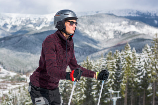 Skier in a glasses and a helmet in the mountains