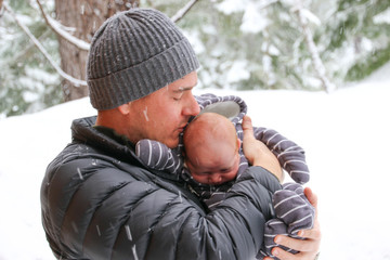 Fototapeta na wymiar People: Father with newborn in snow