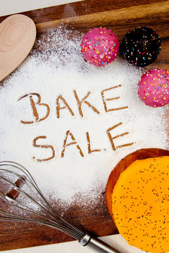 Bake Sale with cake written in flour
