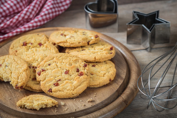 Raspberry cookies on wooden plate