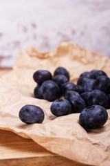 Fresh blueberries on a rustic brown paper background