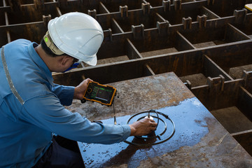 Ultrasonic test to detect imperfection or defect of steel plate in Workshop, NDT Inspection. © jeerawat