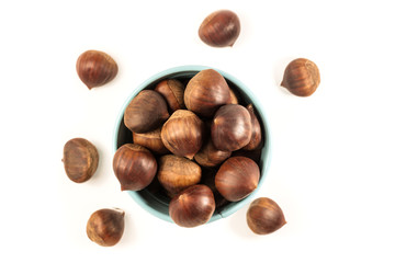Chestnuts in small bucket, on white with copyspace