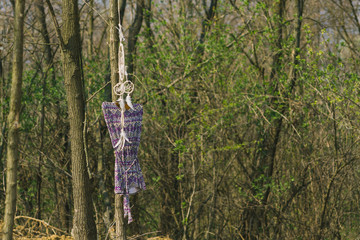 Fototapeta premium On the tree hanging dreamer, a woman's dress. Indie style.