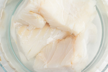 Cod Fish Fillet into a bowl in water