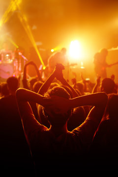 Rock Concert, Cheering Crowd In Front Of Bright Colorful Stage Lights, Hands Behind The Head With Pleasure From The Show