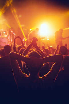 Rock Concert, Cheering Crowd In Front Of Bright Colorful Stage Lights, Hands Behind The Head With Pleasure From The Show