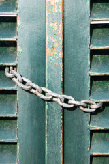 Chain on an old green gate.