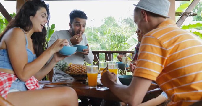 People Eating Noodles Talking, Friends Group Sit At Table On Terrace With View On Tropical Forest Slow Motion 60