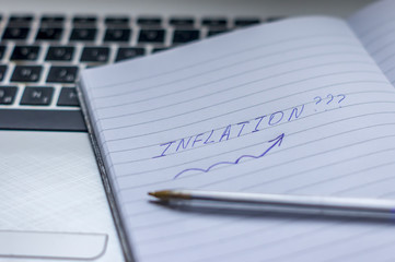 Inflation : Wrote Words On a handbook with note book, pen and notebook