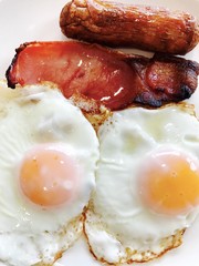 Breakfast with fried eggs, bacon and sausage 
