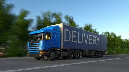 Speeding freight semi truck with DELIVERY caption on the trailer. Road cargo transportation. 3D rendering