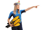 Woman in wetsuit with snorkeling equipment pointing in the distance
