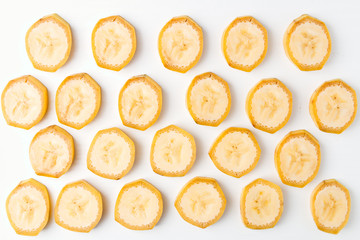 Background of sliced banana slices on white table