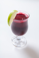 Hot mulled wine with spices, apple and orange on white background