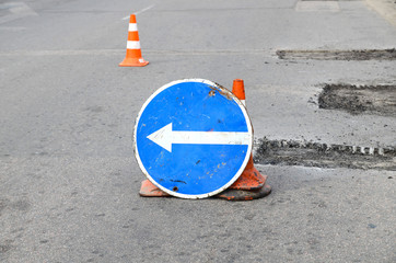  Road repairs. Plastic orange cone on the asphalt road. Detour sign on the street, roadworks....