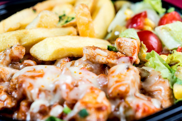 Chicken skewers with sauce and golden French fries potatoes