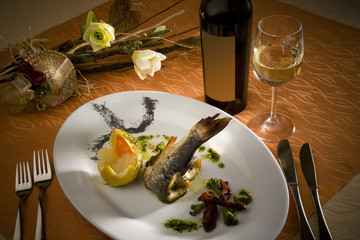 Beautifully arranged plate for celebration with glass of wine and flowers
