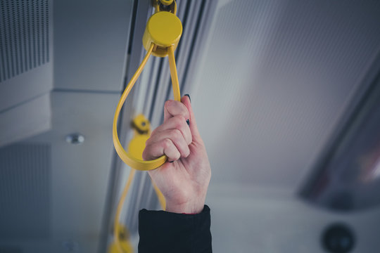 Close Up Of Hand Holding Handle In Bus, Tram, Metro Or Subway. Public Transportation Concept