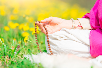 Recitation of mantras holding the mala during a yoga practice