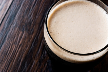 Dark Beer on wooden surface.