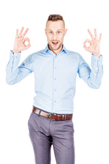 Naklejka premium businessman showing OK while standing against white background