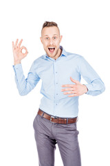 businessman showing OK while standing against white background
