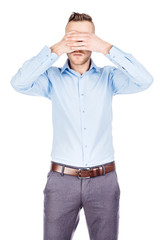 portrait young businessman covering his eyes with his hand. emotions, facial expressions, feelings, body language, signs. image on a white studio background.